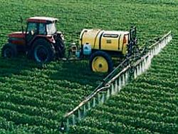 Tractor spraying a green field