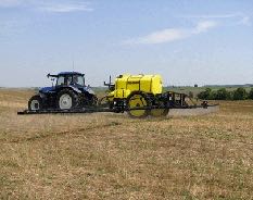Tractor pulling a yellow sprayer